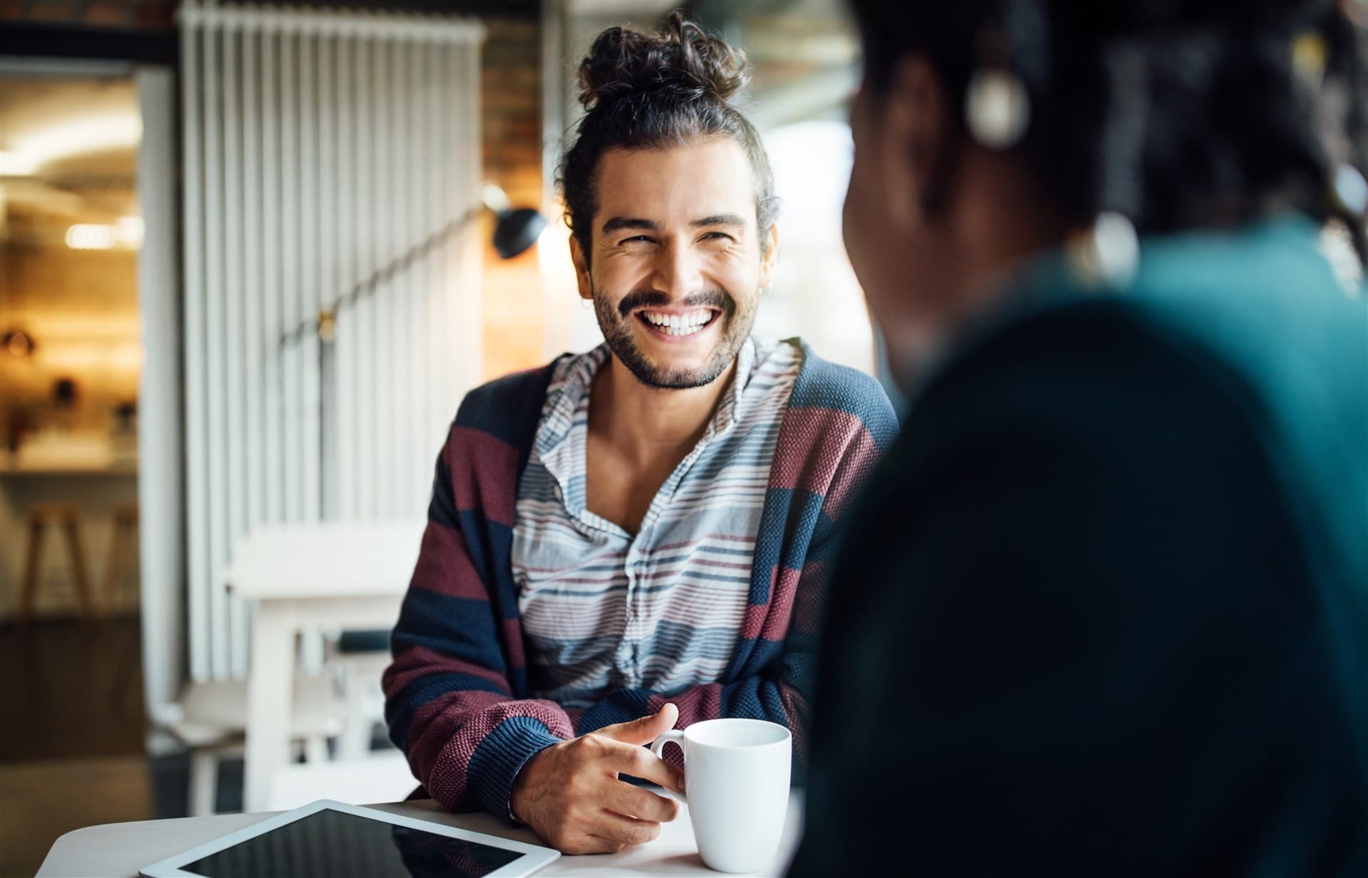 Two people talking over coffee